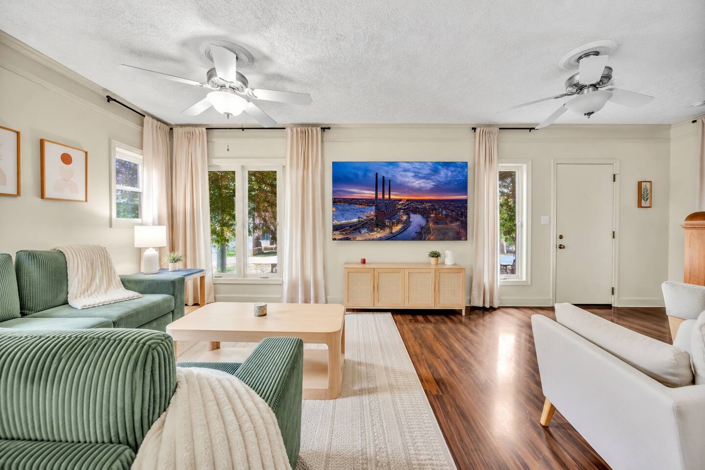 Bright open-plan living room with comfortable seating and Smart TV