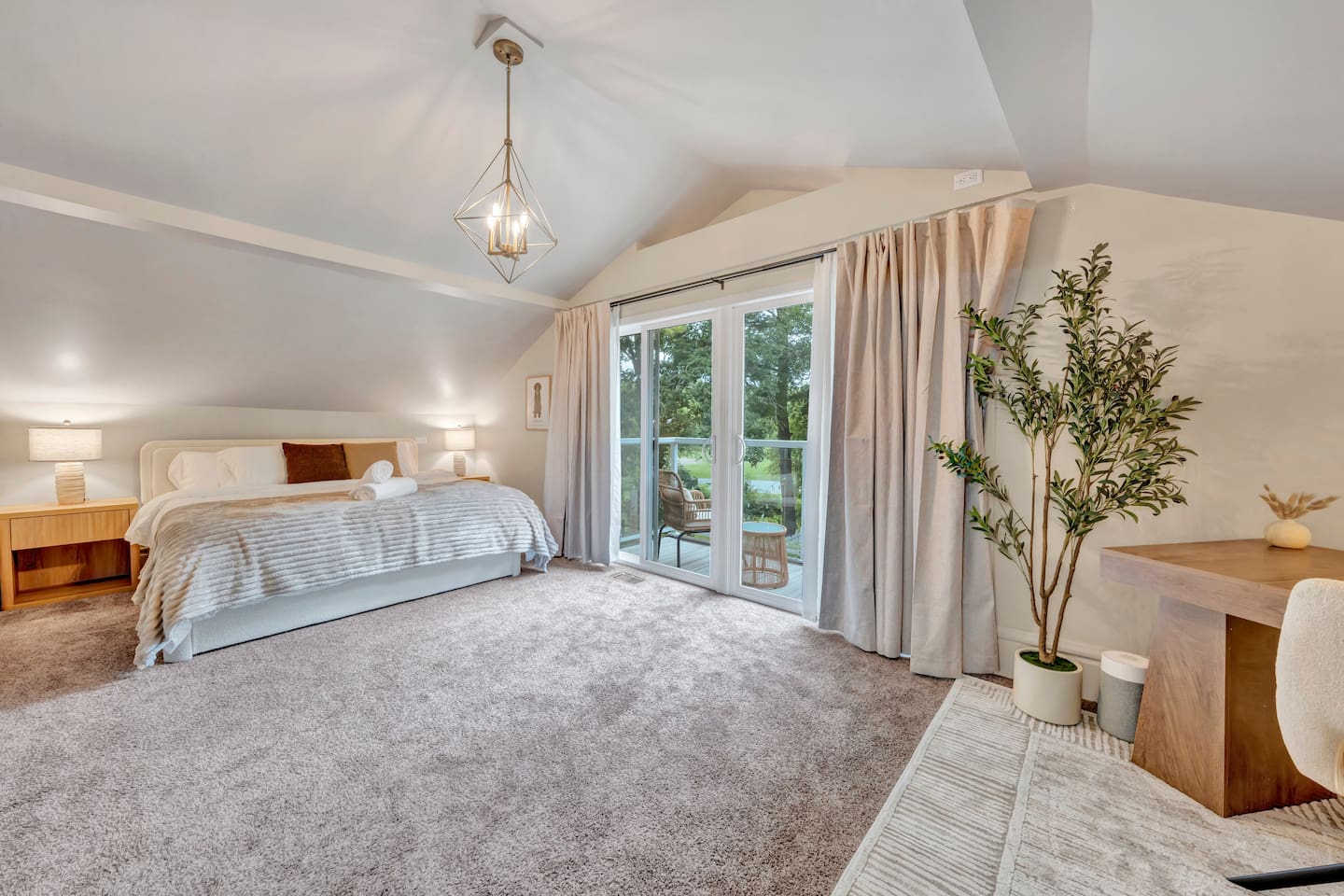 Primary king bedroom with access to a private balcony