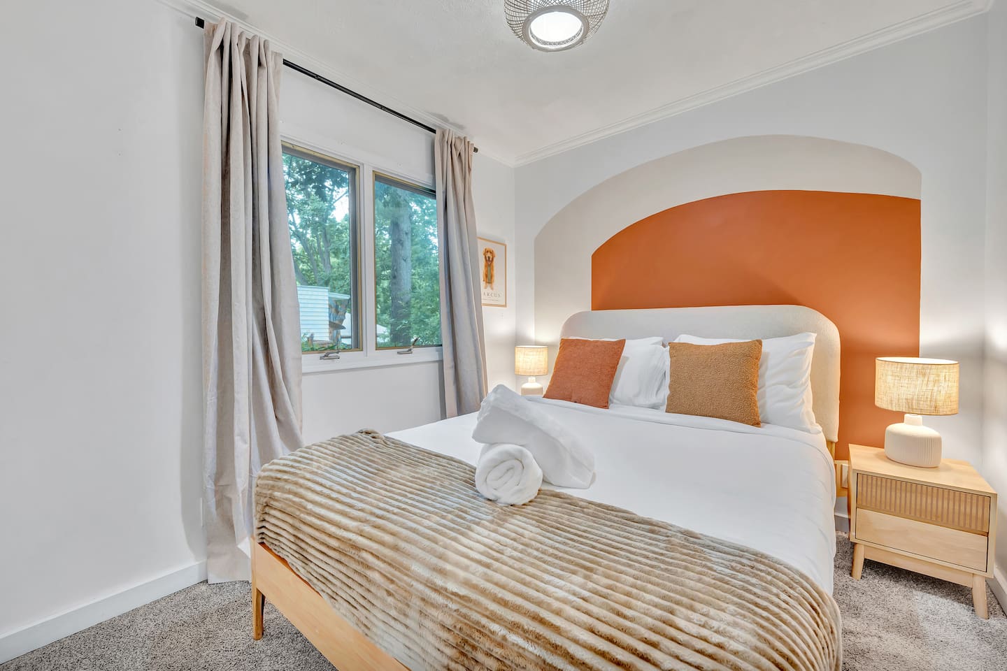 Main-floor queen bedroom with warm terracotta accent wall